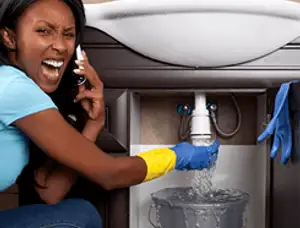 Emergency plumbing repair for a leaking sink drain under a bathroom vanity in Long Beach, CA