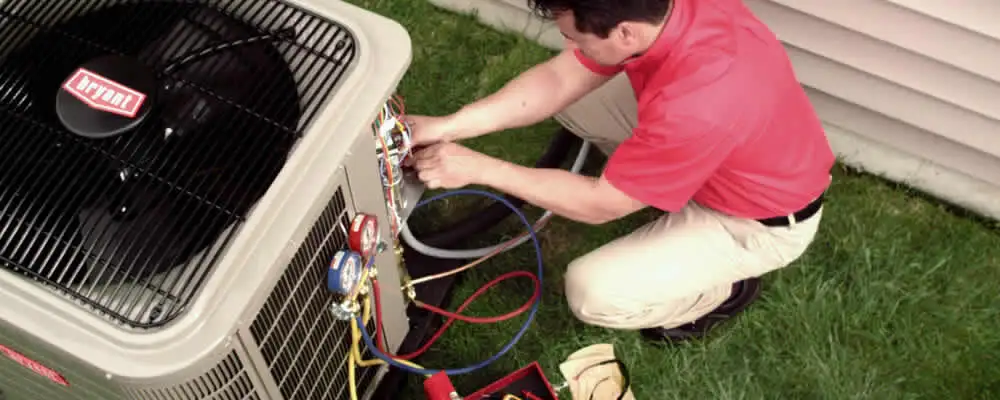 HVAC technician servicing an outdoor air conditioner unit in Long Beach, CA
